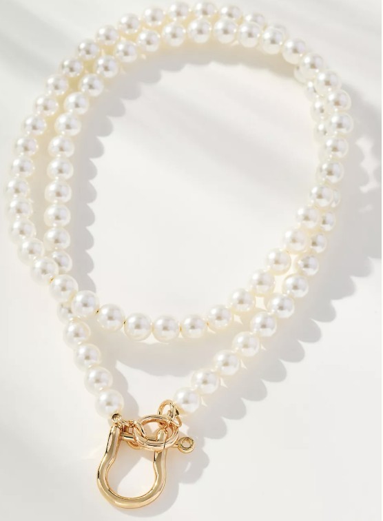 Layered pearl statement necklace styled with a cream fall sweater