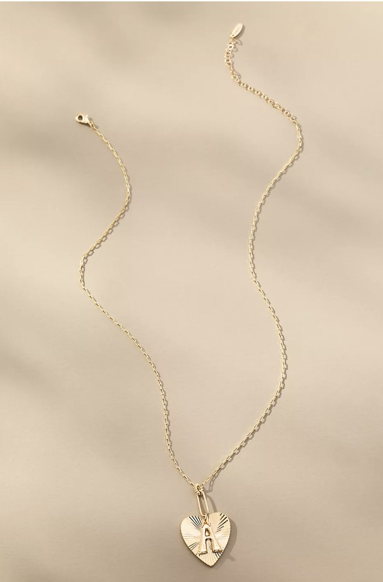 Oversized pendant necklace worn with a fall knit dress