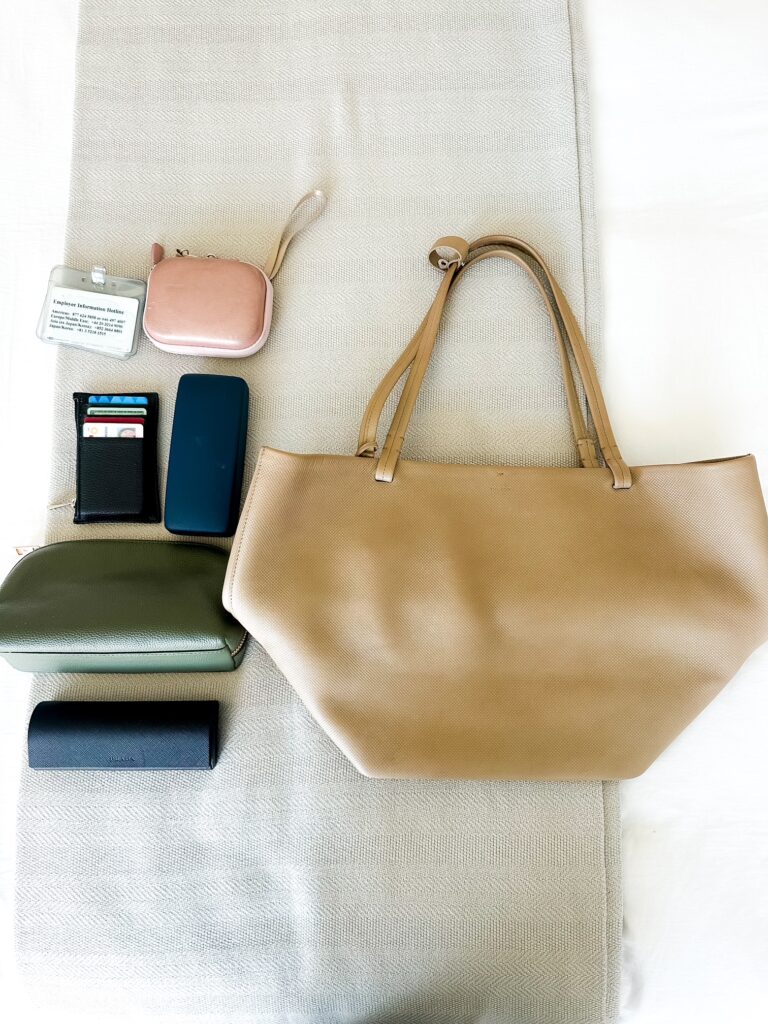 flat lay of a designer handbag from Vivrelle while wearing a neutral summer outfit, showcasing luxury accessory rental for everyday style