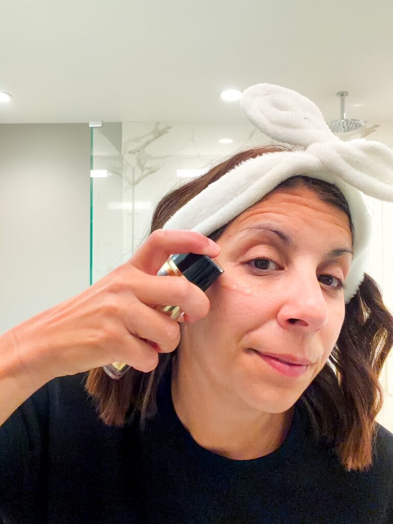 Woman over 40 using ILONA Beauty skincare products at home